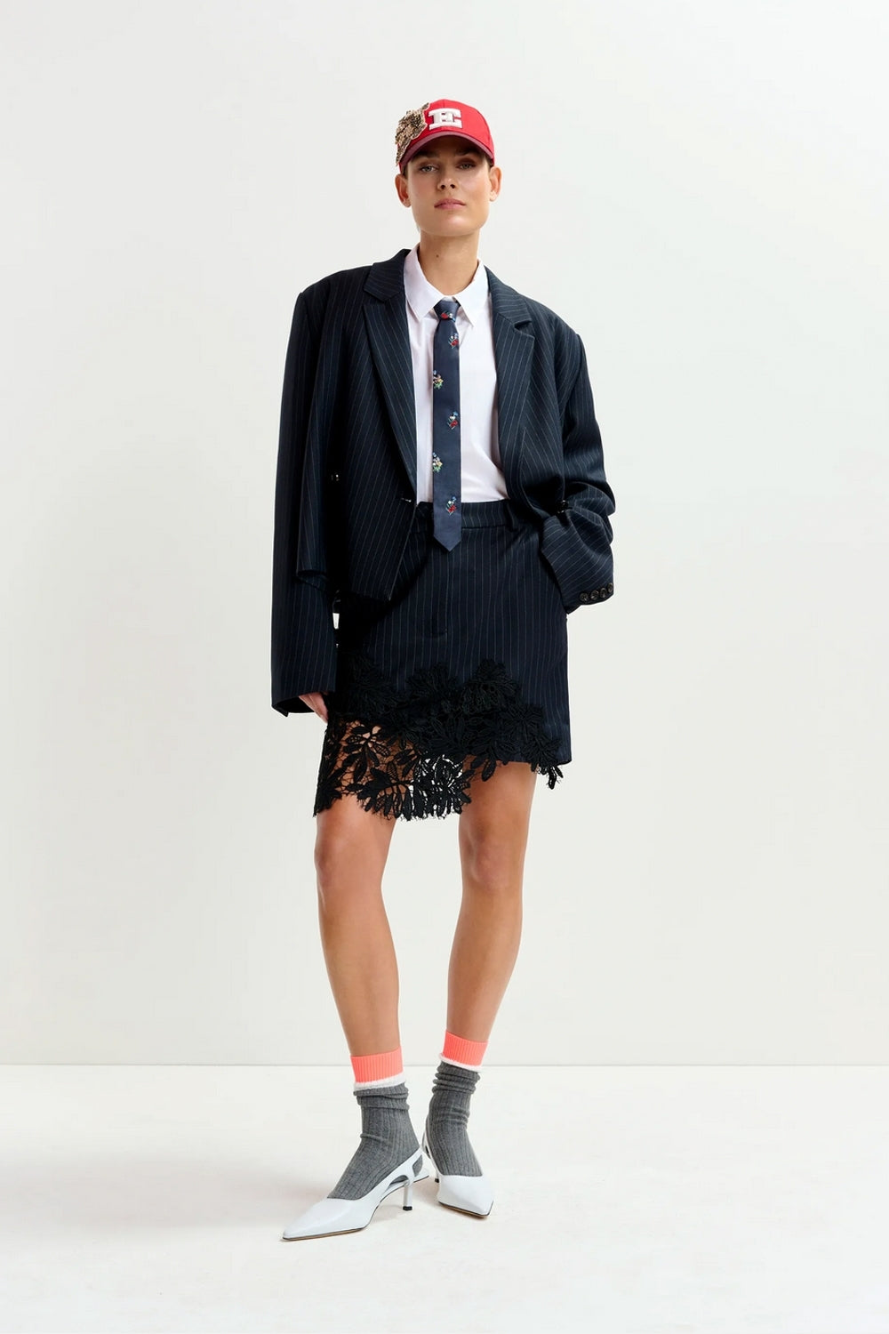 Interior Pinstripe Asymmetric Skirt with Lace Applique in Black