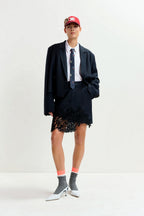 Interior Pinstripe Asymmetric Skirt with Lace Applique in Black