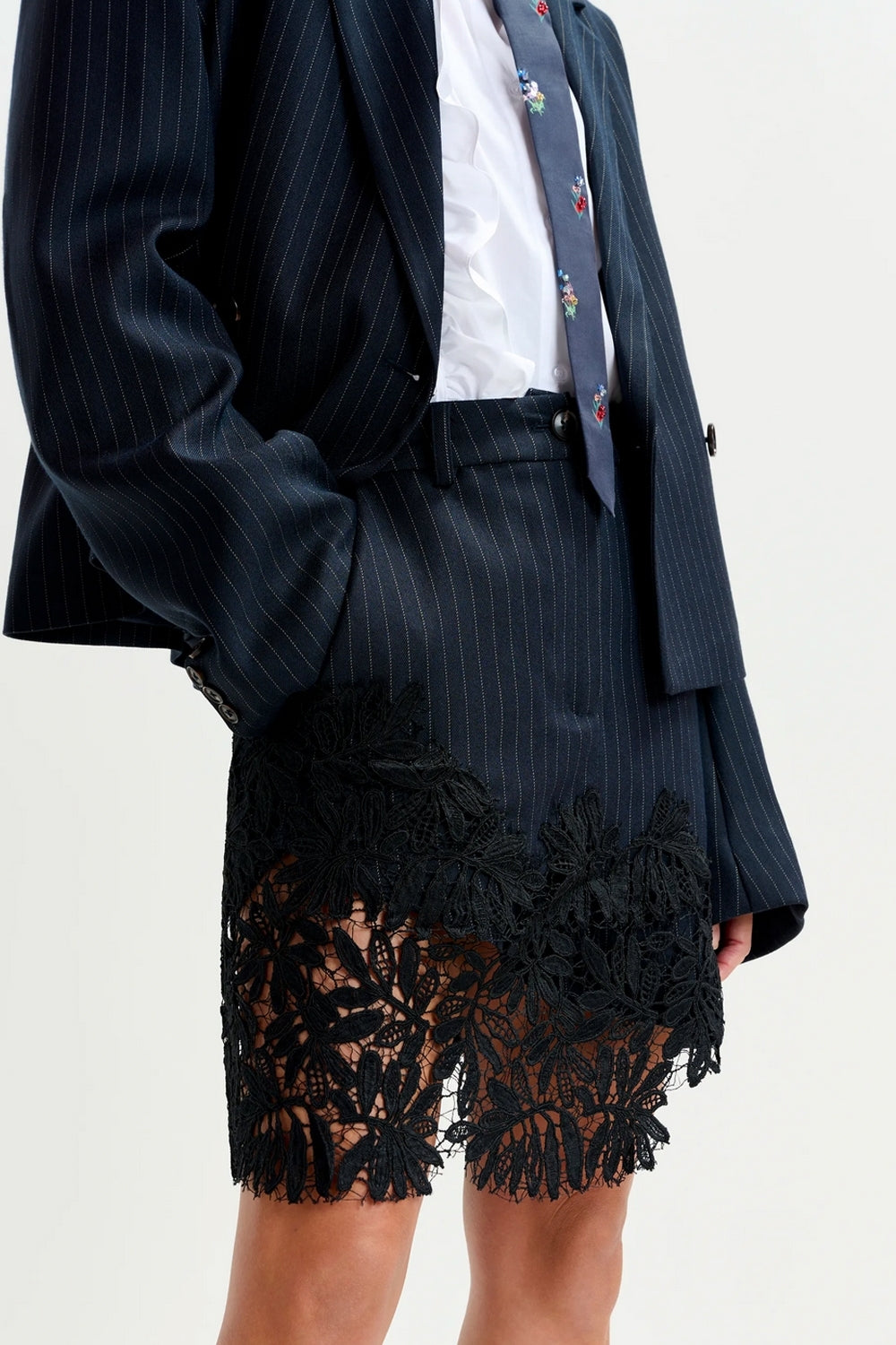 Interior Pinstripe Asymmetric Skirt with Lace Applique in Black