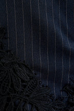 Interior Pinstripe Asymmetric Skirt with Lace Applique in Black